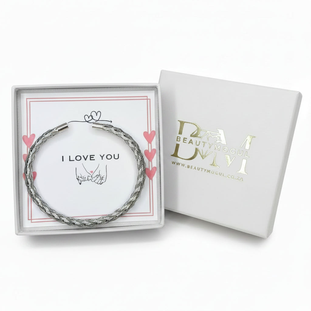 A silver-toned twisted wire bracelet presented in an open white gift box with a printed card that says 'I LOVE YOU,' next to the closed branded box on a white background.