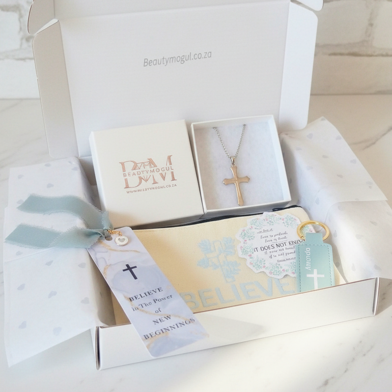 A beautifully arranged religious gift box  on a white marble surface.