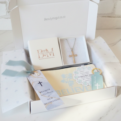 A beautifully arranged religious gift box  on a white marble surface.